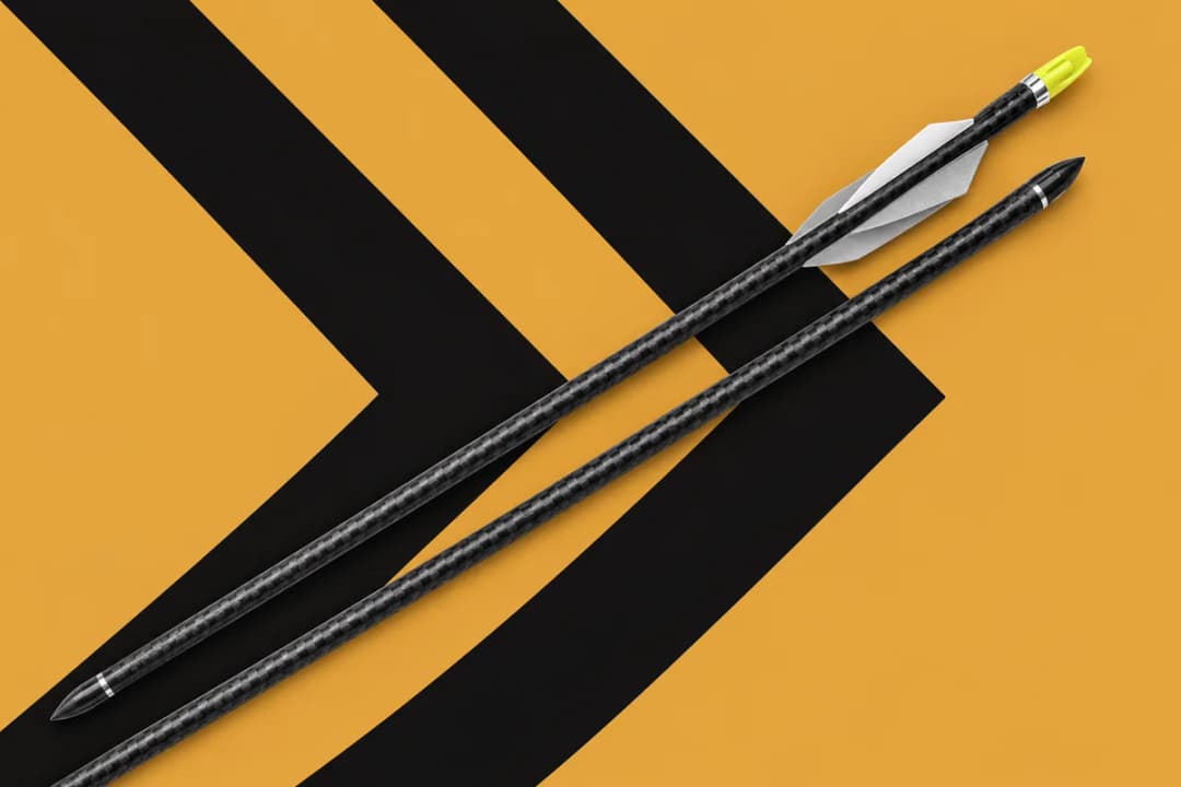 Two black carbon bolts lying on a diagonal over a gold background with bold black chevron stripes, one with white vanes and a lime-yellow nock